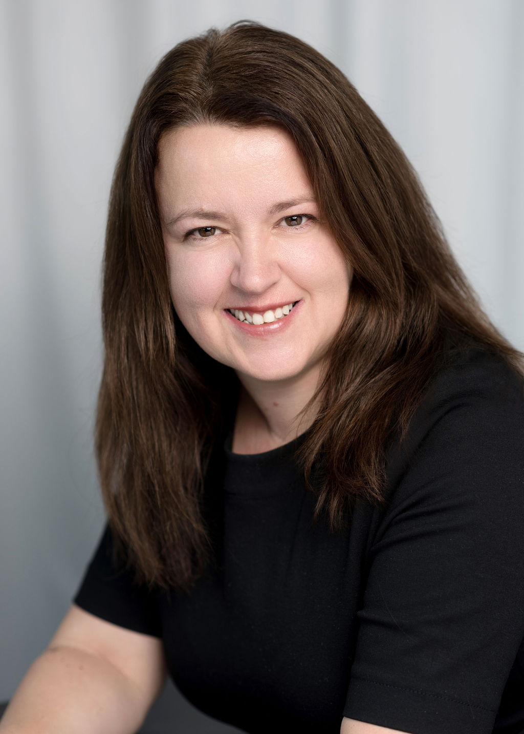 Logical BI founder Pauline Healey wearing a black t-shirt looking at the camera and smiling