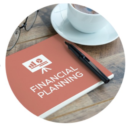 Orange Financial Planning notebook with a black pen resting on top of it