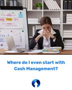 A lady sits at her desk with her face in her hands, she has paperwork on her desk and a whiteboard of post-it notes