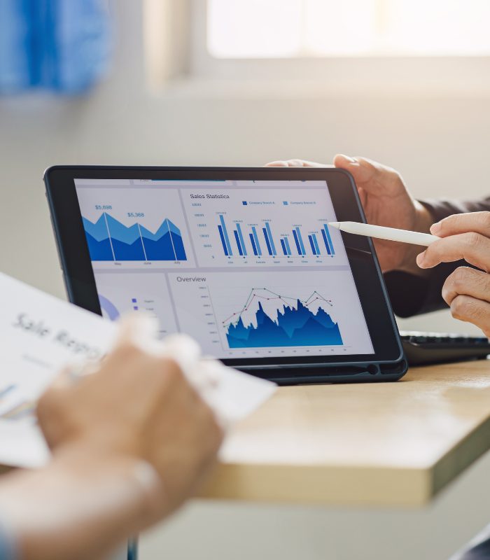 A hand ponts to a screen showing financial growth forecasts