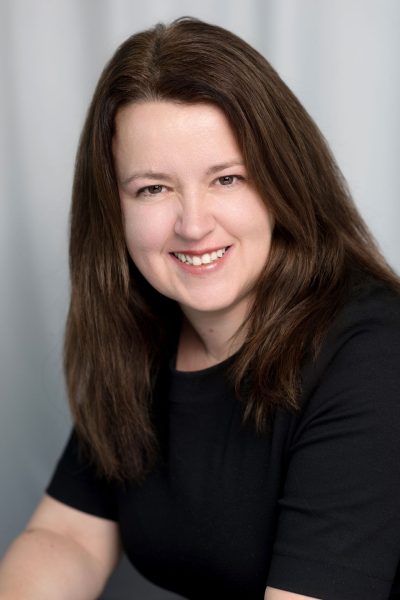 Logical BI founder Pauline Healey wearing a black t-shirt looking at the camera and smiling